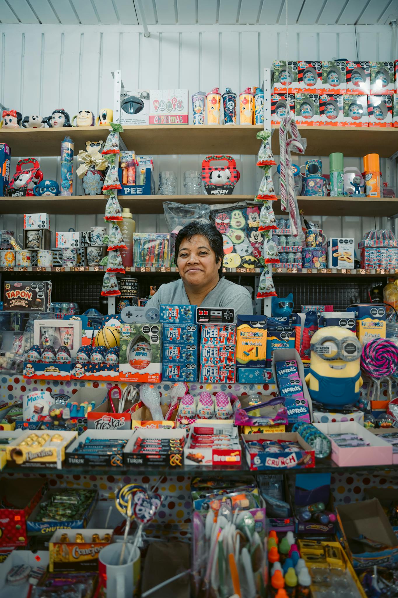 Woman in a colorful store in Mexico City showcasing diverse merchandise and toys.