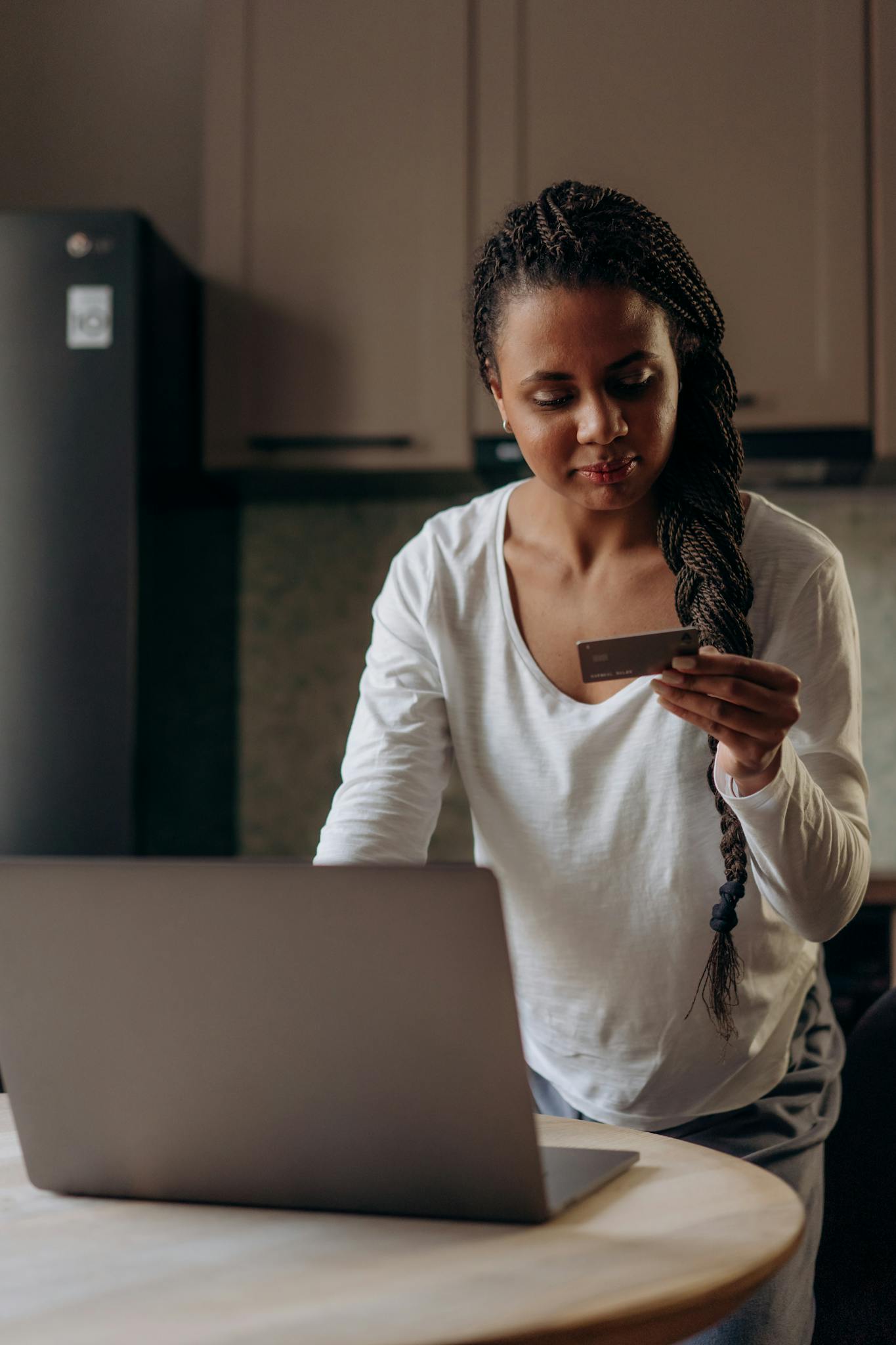 Young woman using laptop and credit card for online shopping at home.